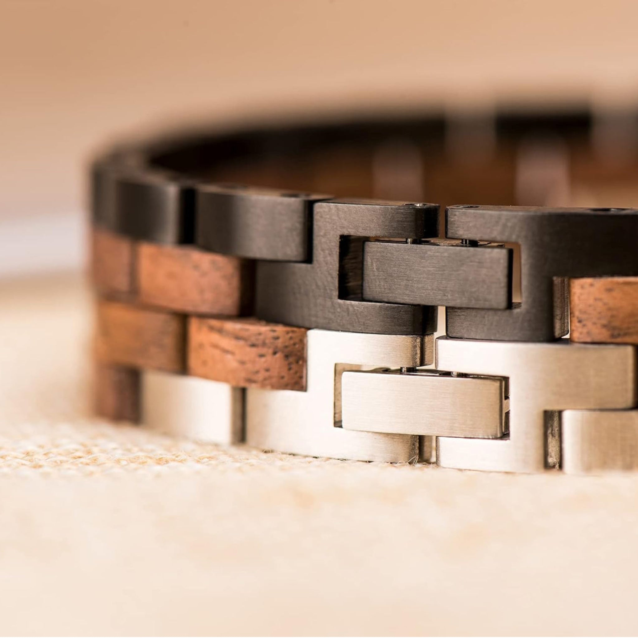 Bracelet with wooden and metal links on a textured surface